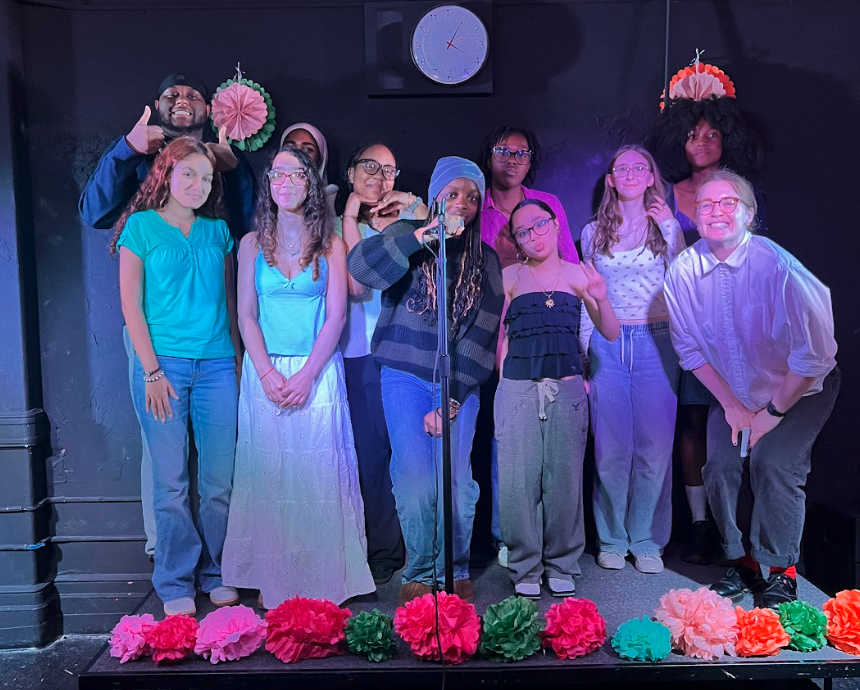 Poetry club advisor Roberts poses with performers at a recent MBHS Poetry Night.